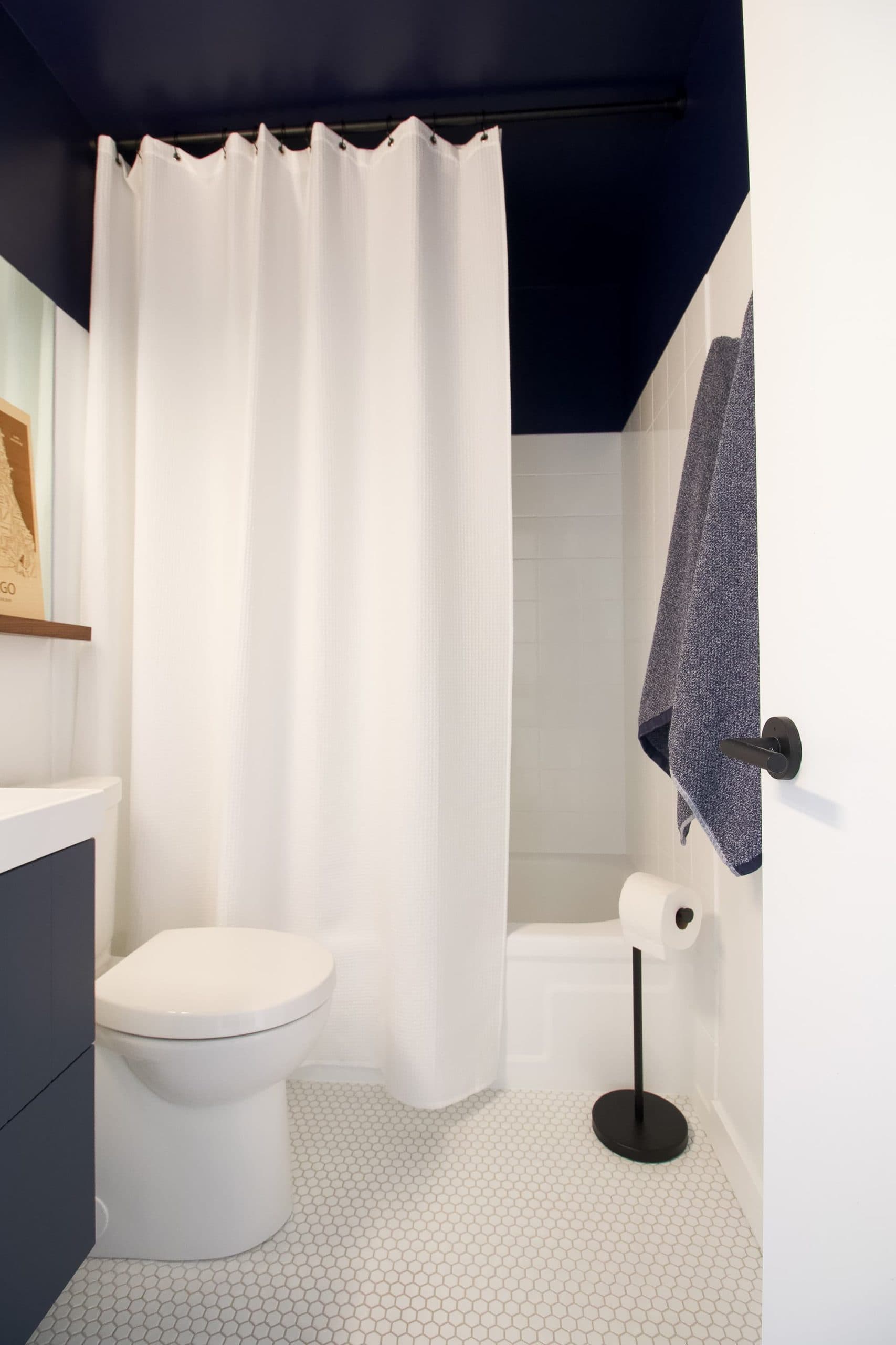 White shower curtain and dark ceiling