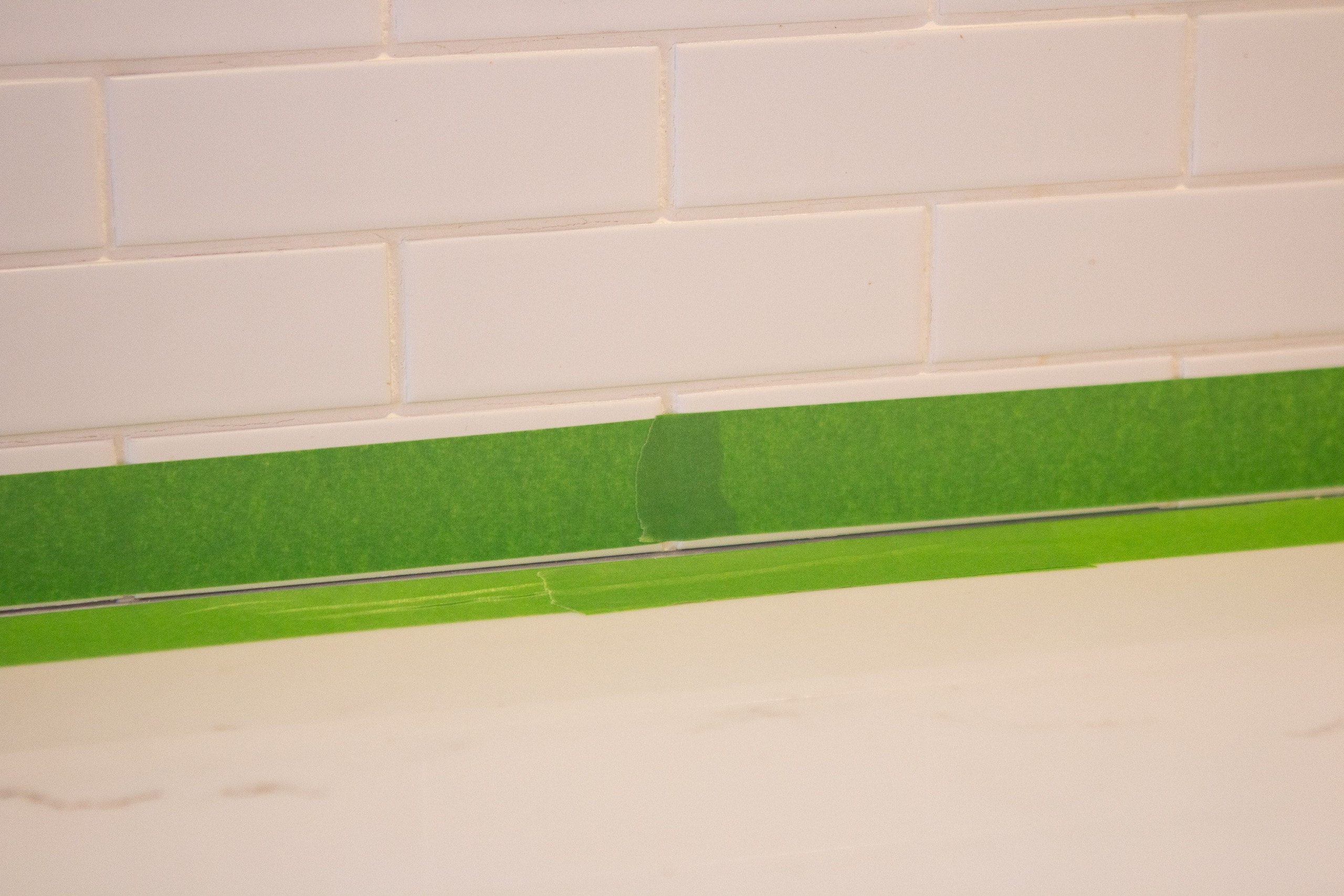 Use painter's tape when caulking a backsplash