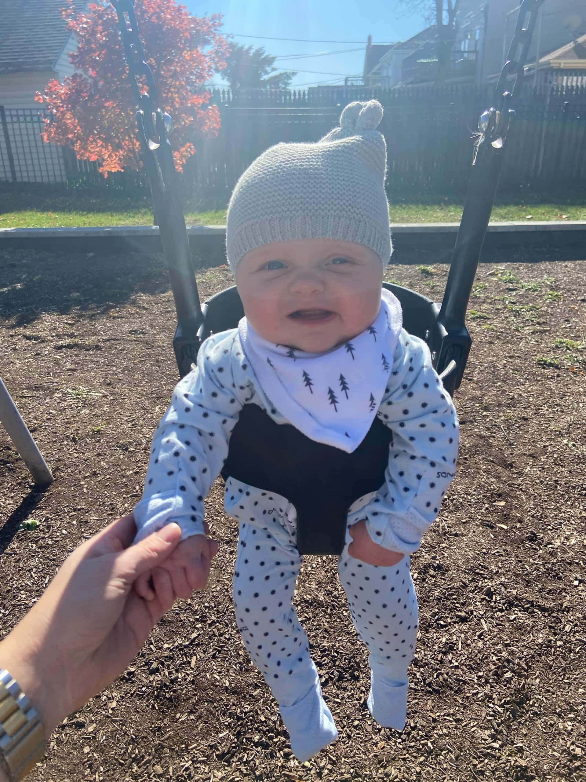 Rory enjoying the swings at the park