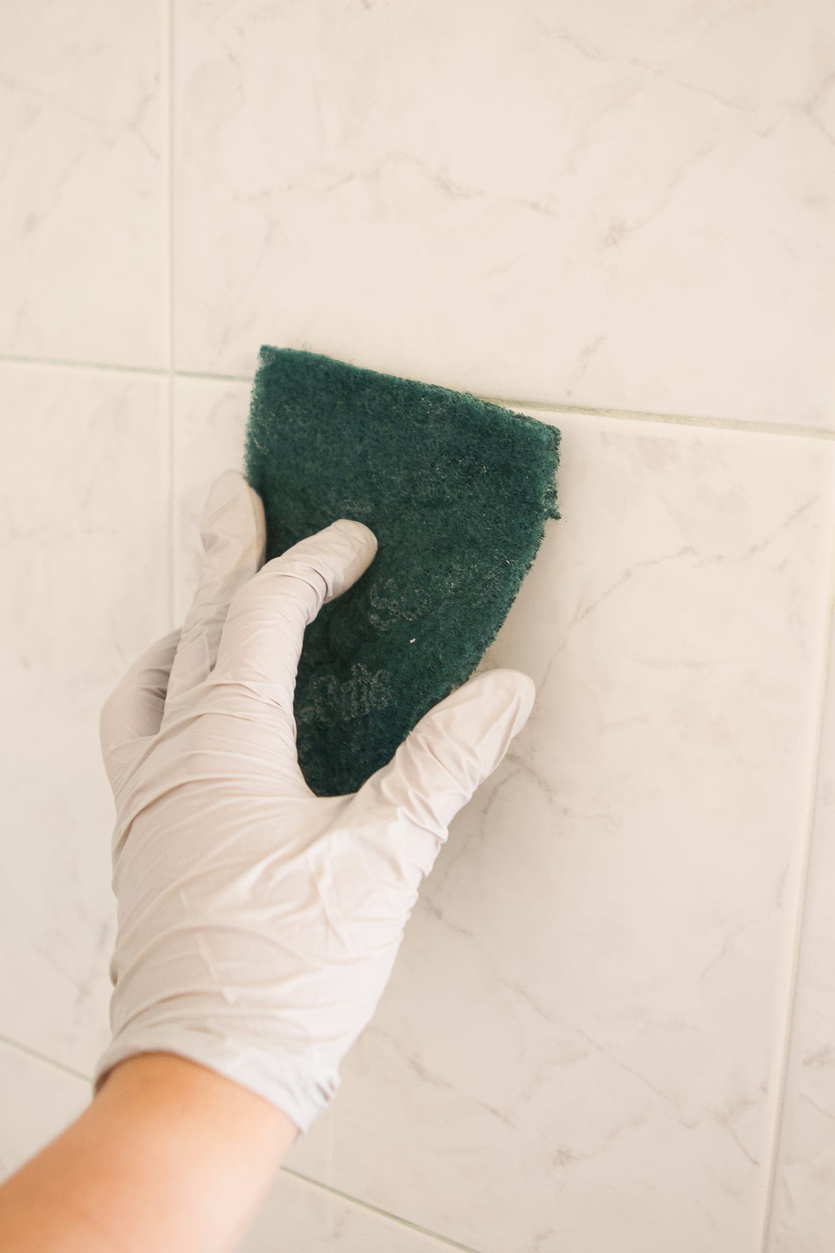 use an abrasive pad to clean the shower tile