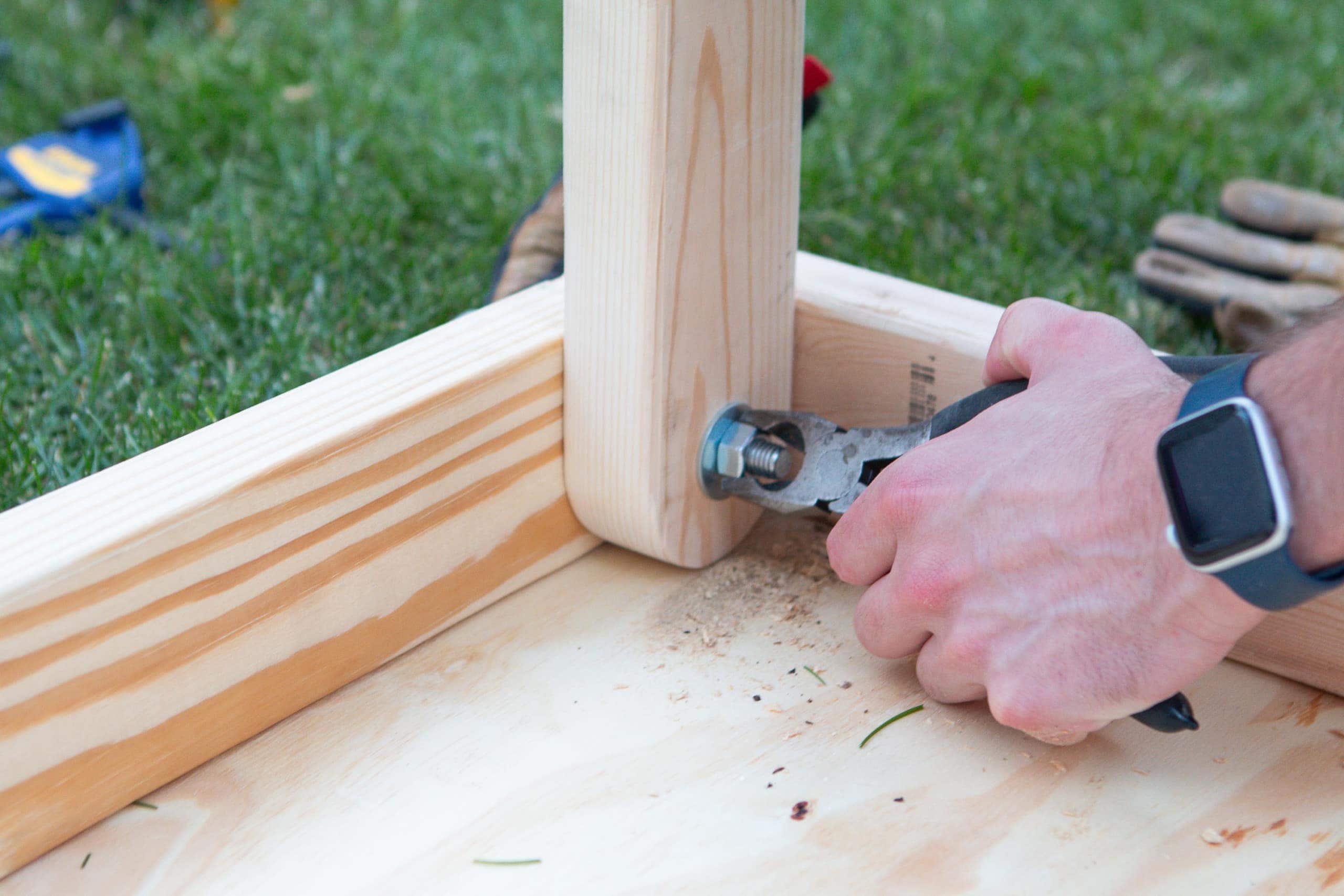 attaching the legs of the cornhole boards