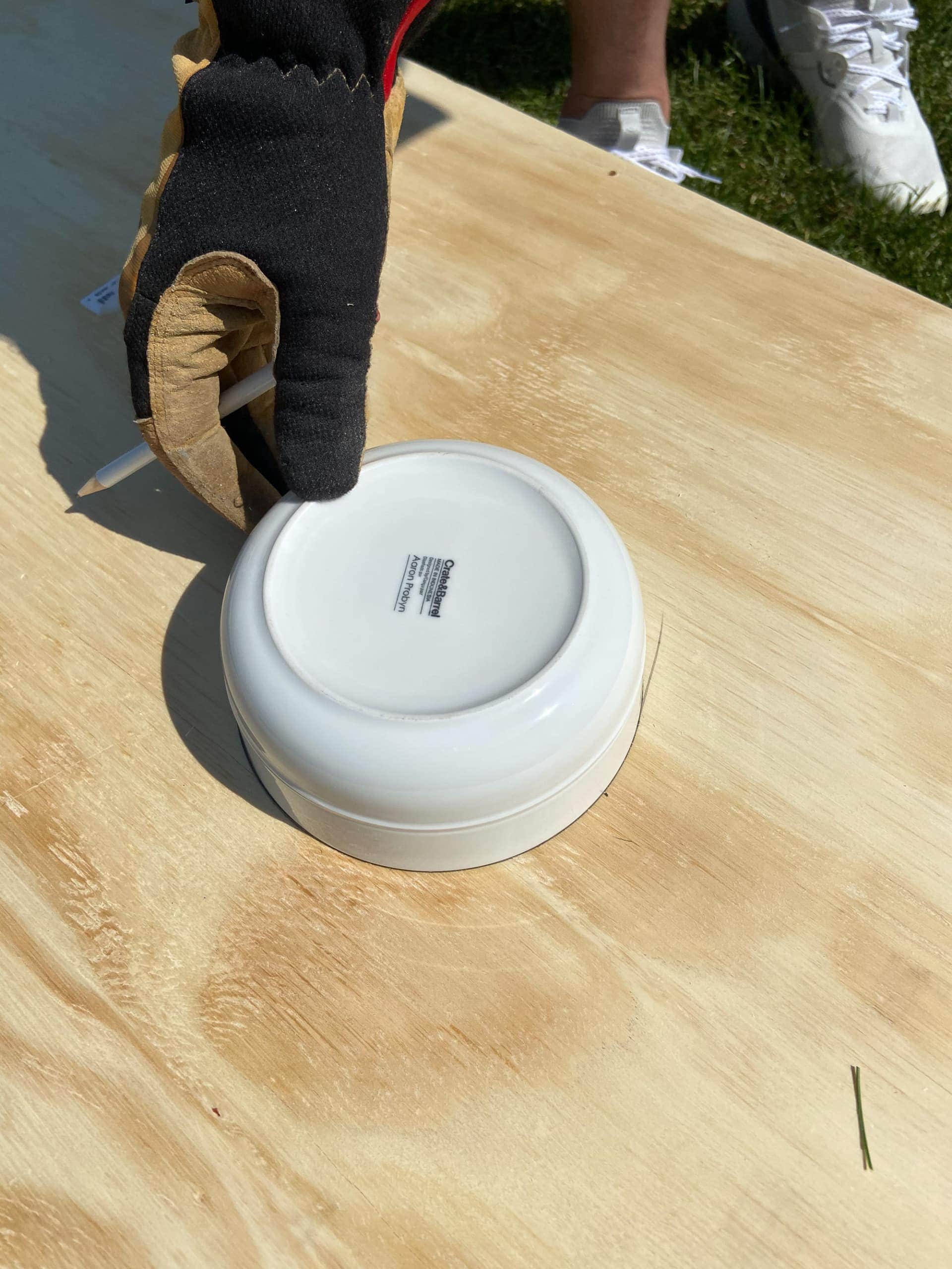 Using a bowl to make the hole for cornhole