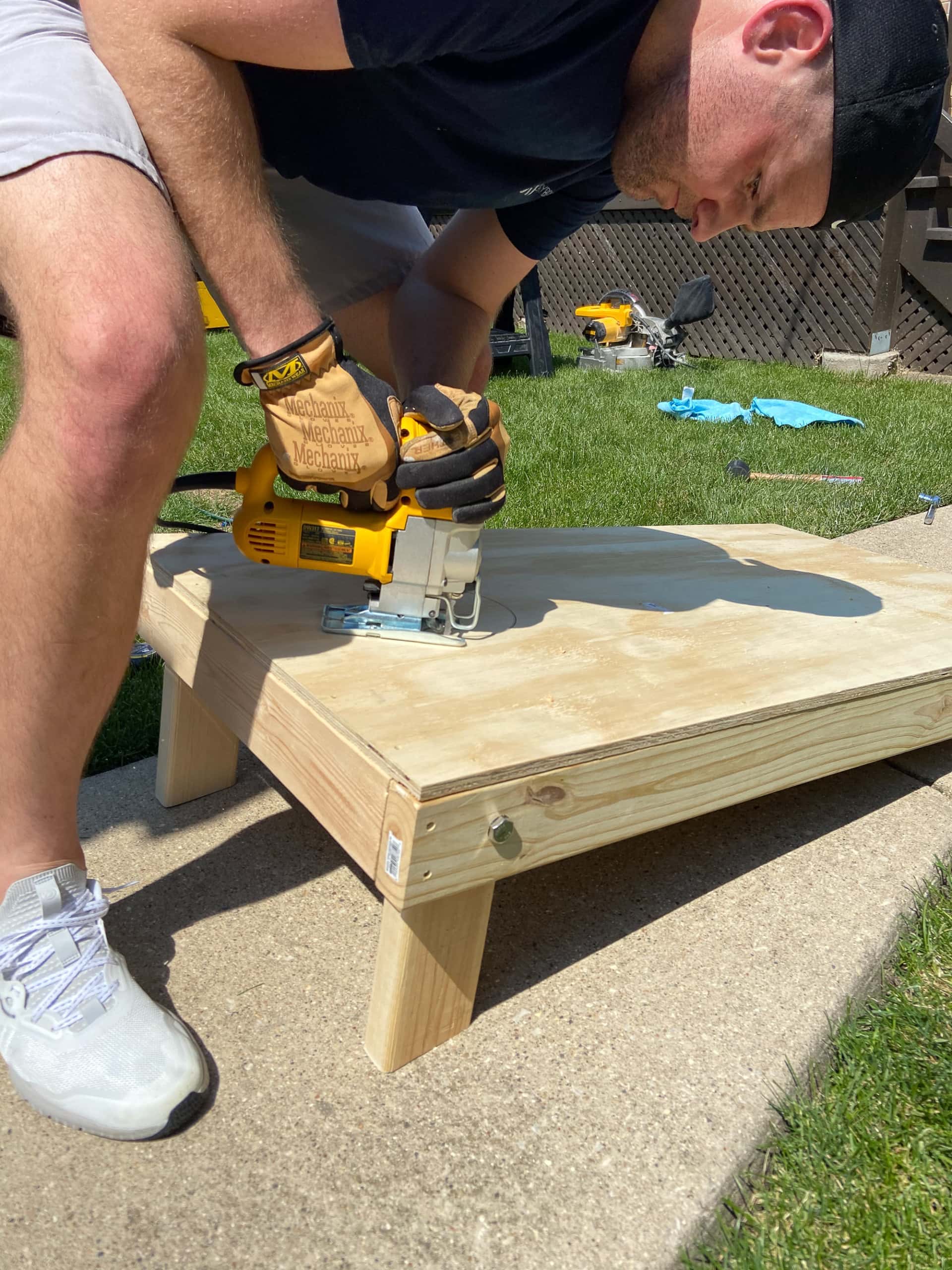 use a jigsaw to cut the cornhole hole