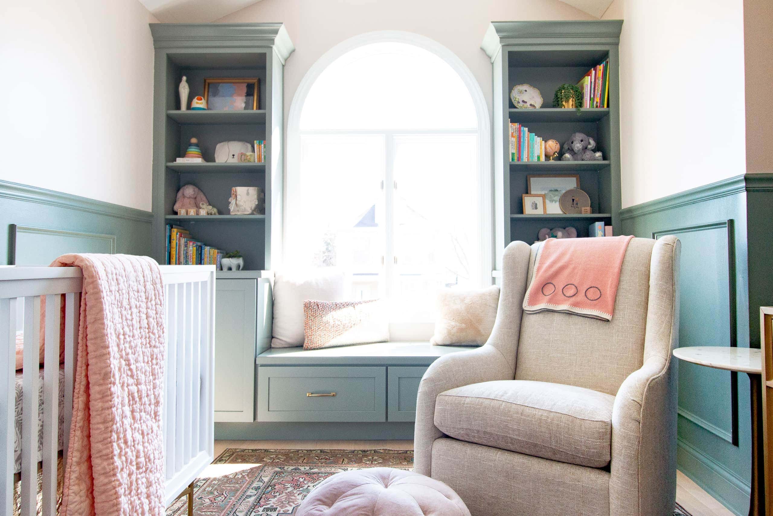 Sage green built-is in a baby girl's nursery