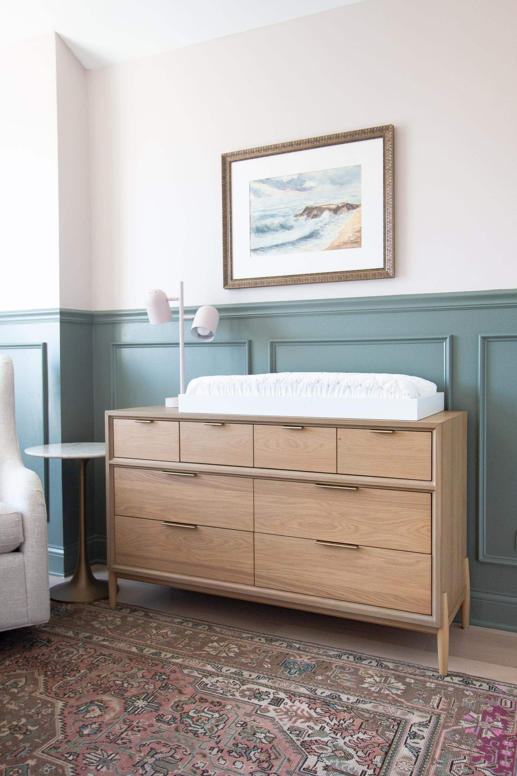 Nursery before and after featuring a wood dresser and changing pad cover