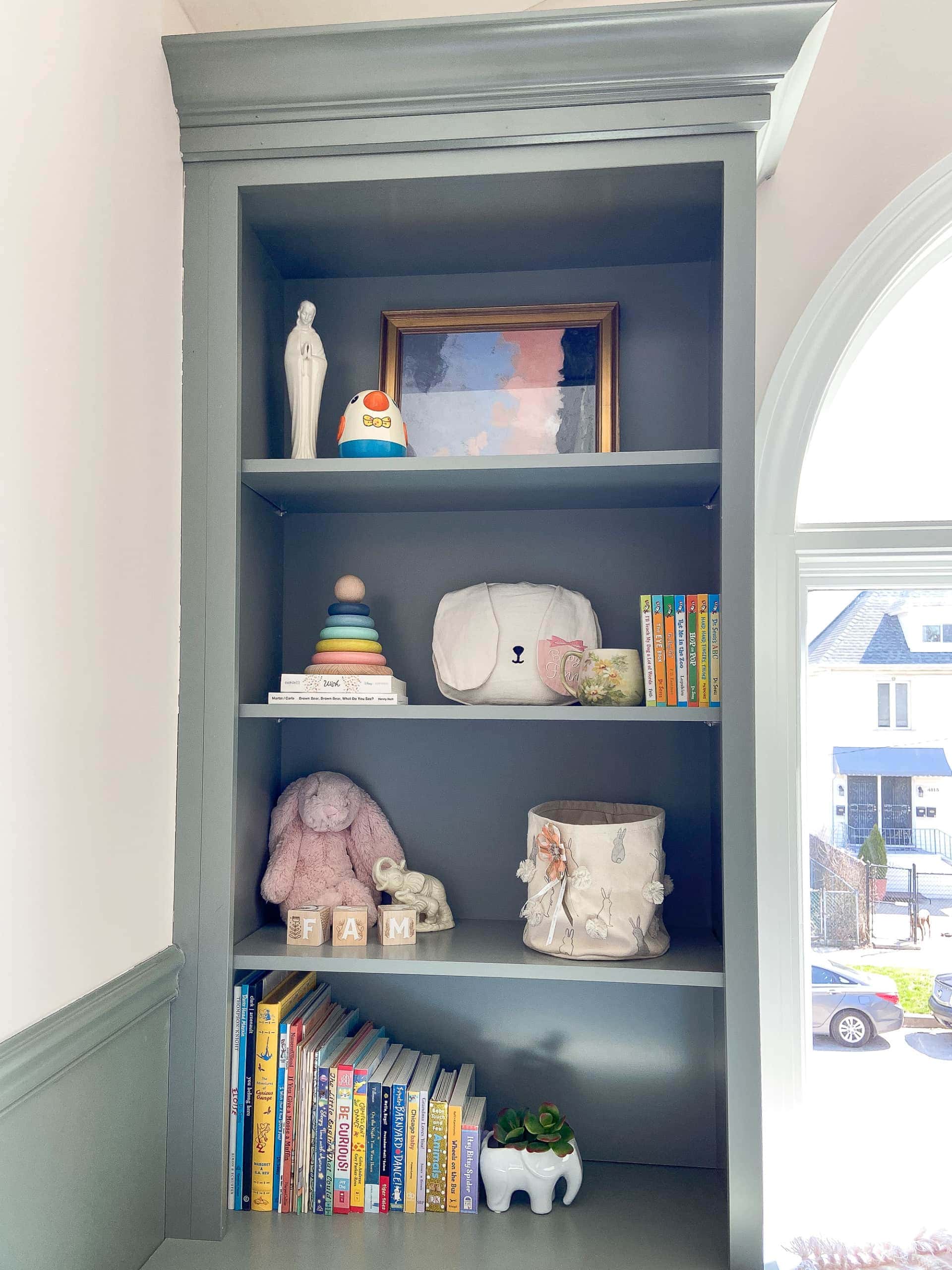 Sage green built-ins in a nursery