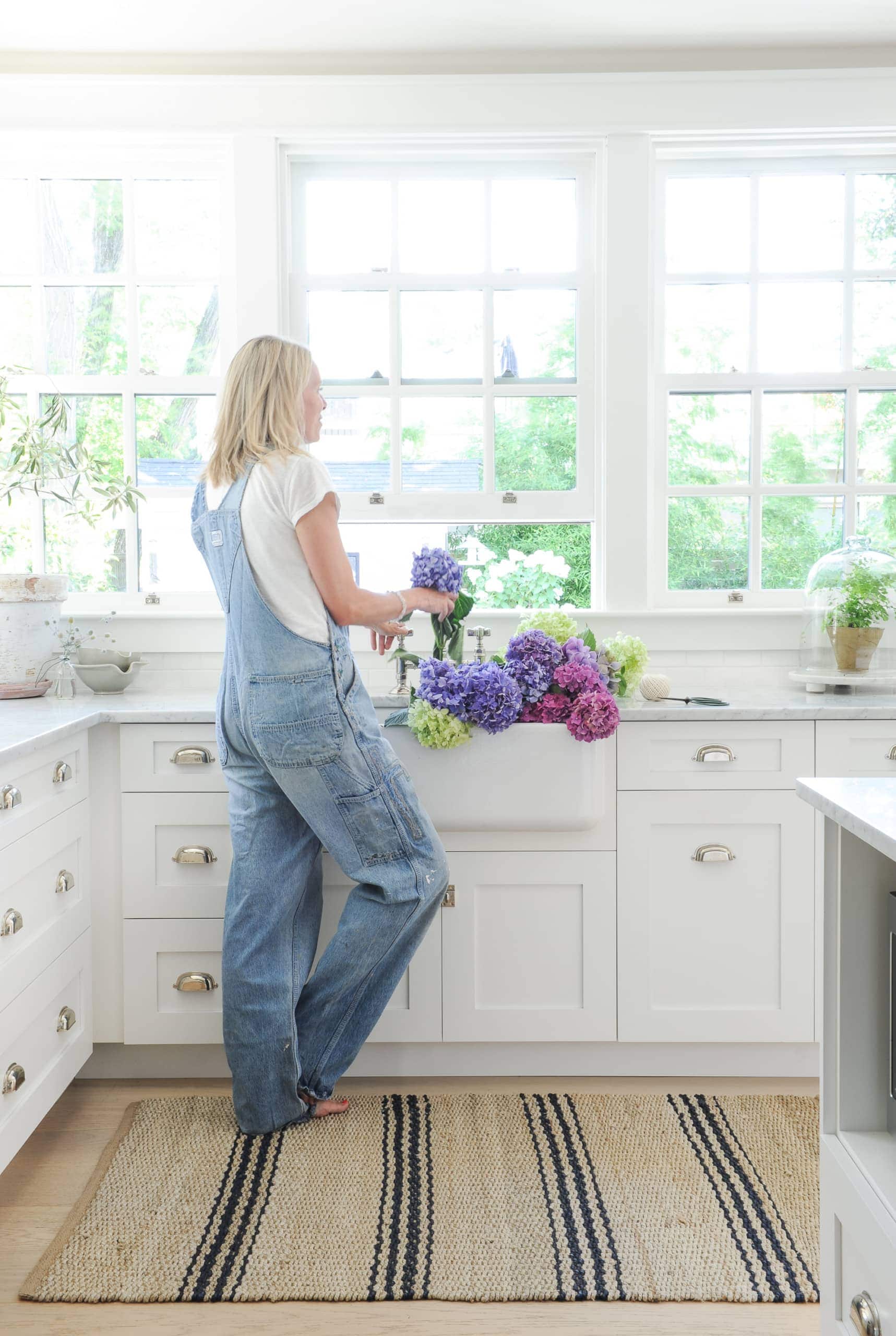 Tracey cutting flowers in her kitchen sink