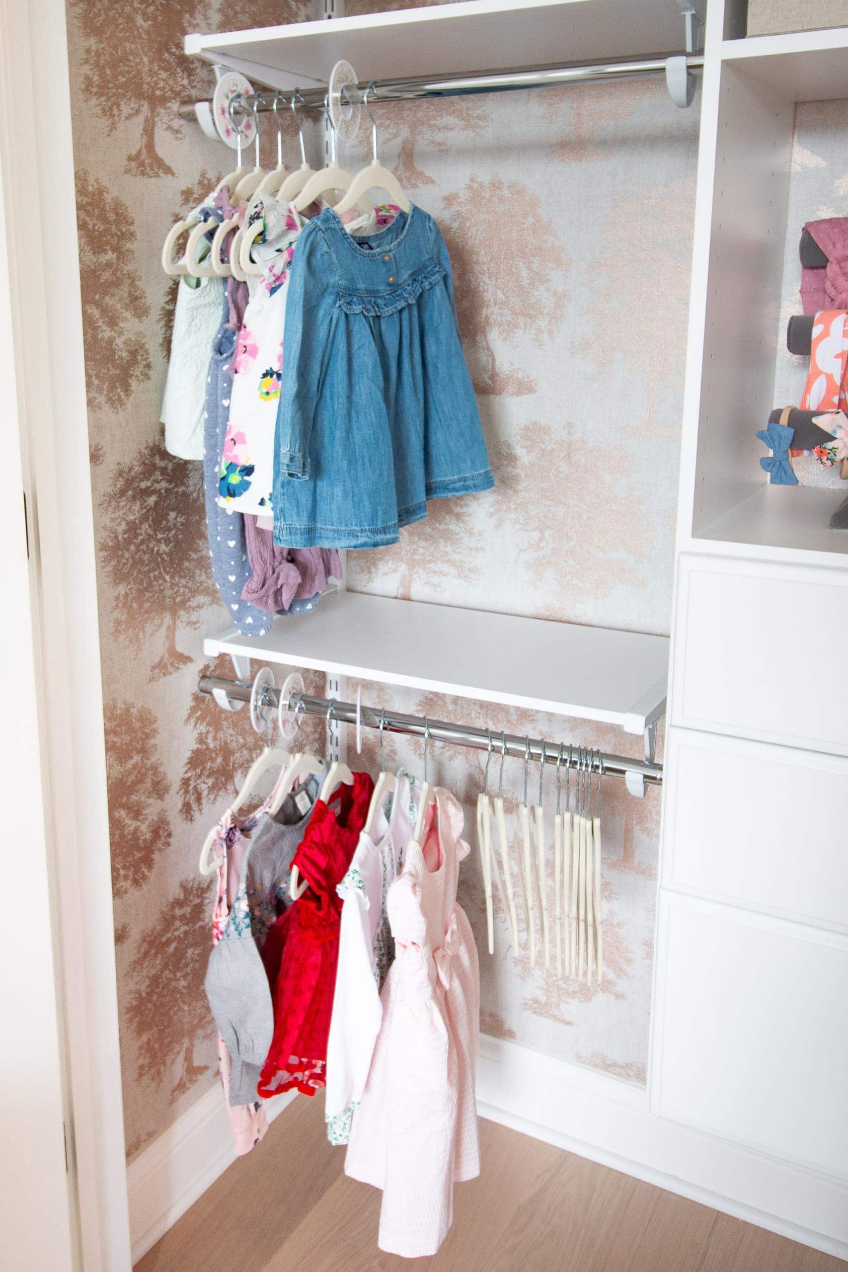 Rubbermaid shelves and rods in this organized nursery closet