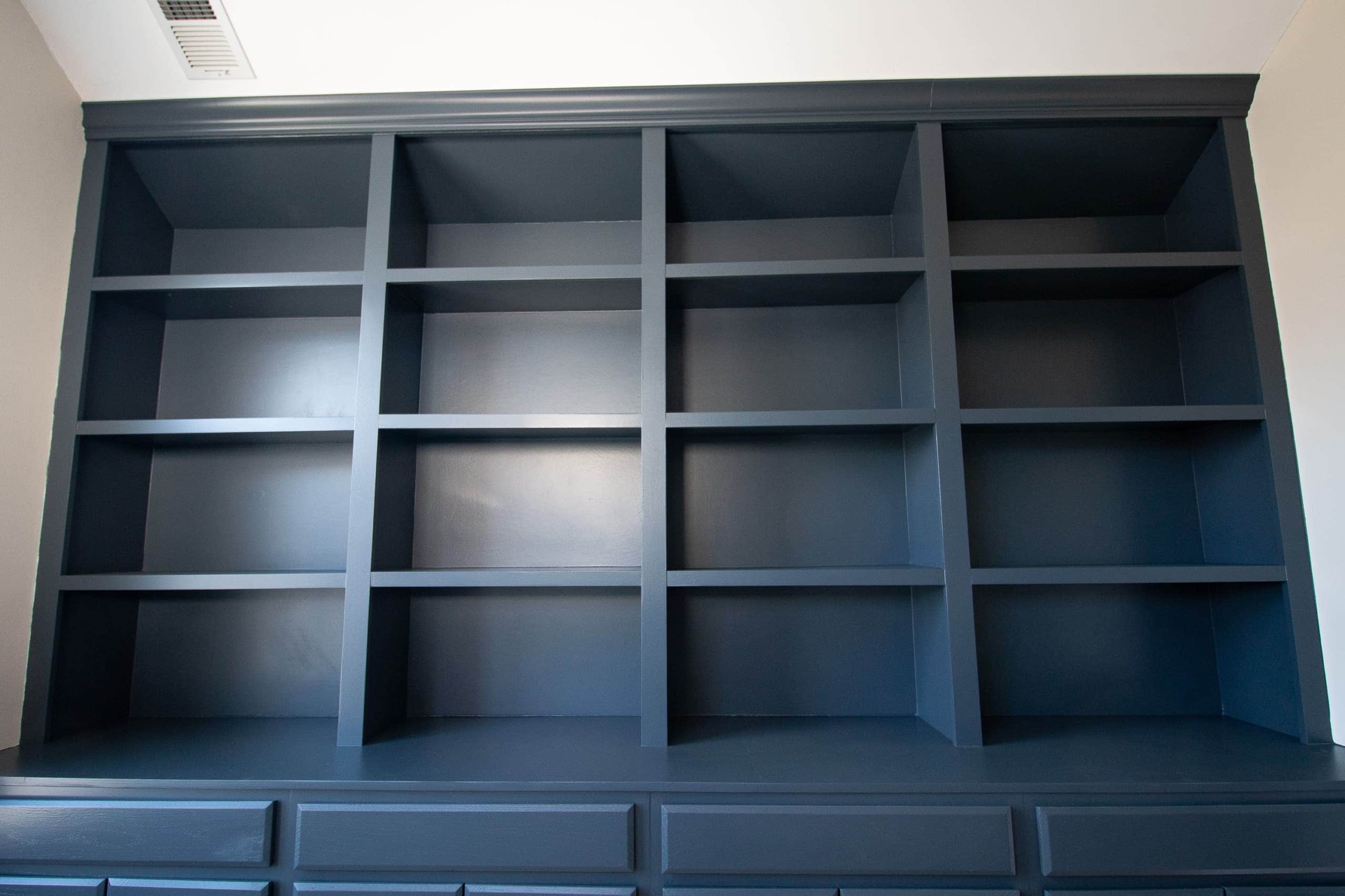 Blue painted built-in bookshelves