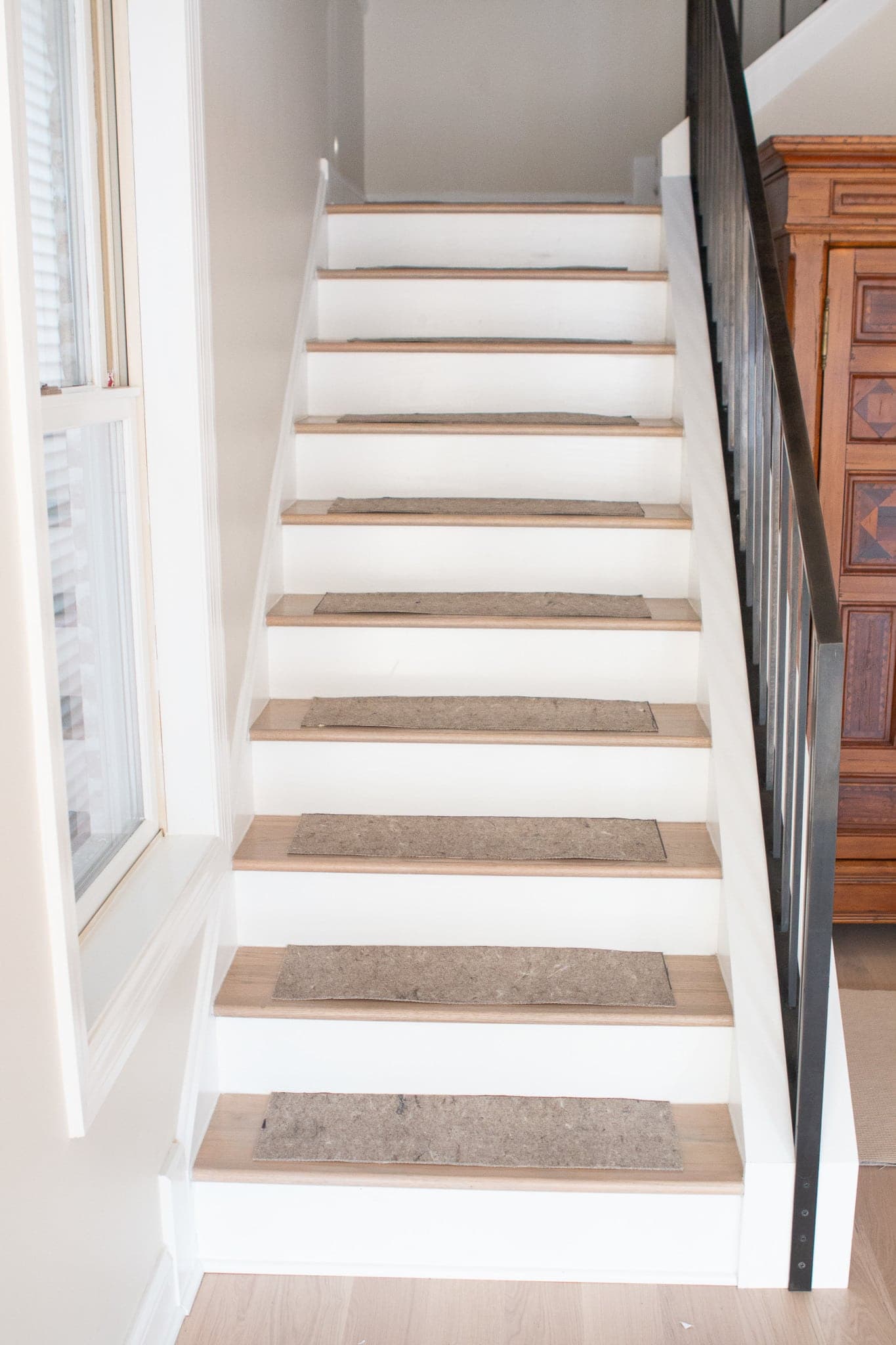 Adding rug pads to the stairs