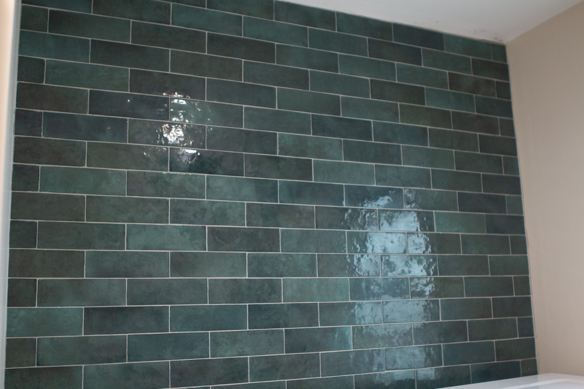 Grouting green tile in the laundry room