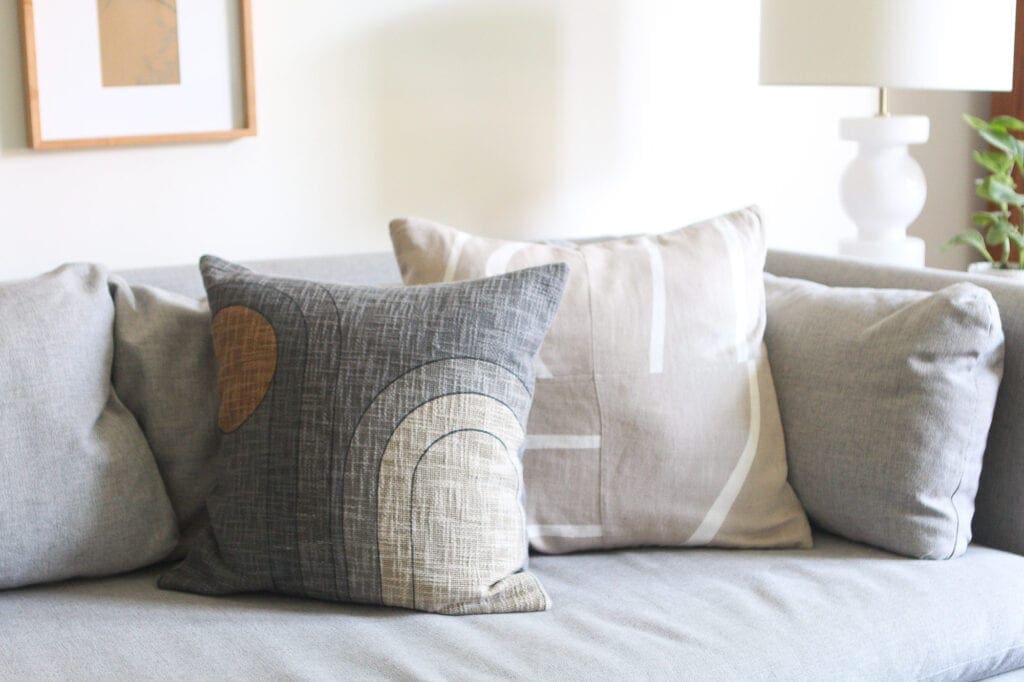 Neutral textiles on a gray couch
