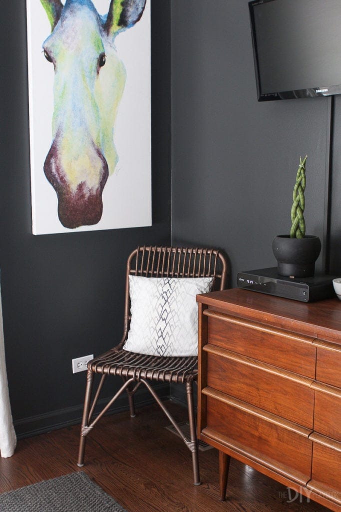 Chair and artwork in a master bedroom corner