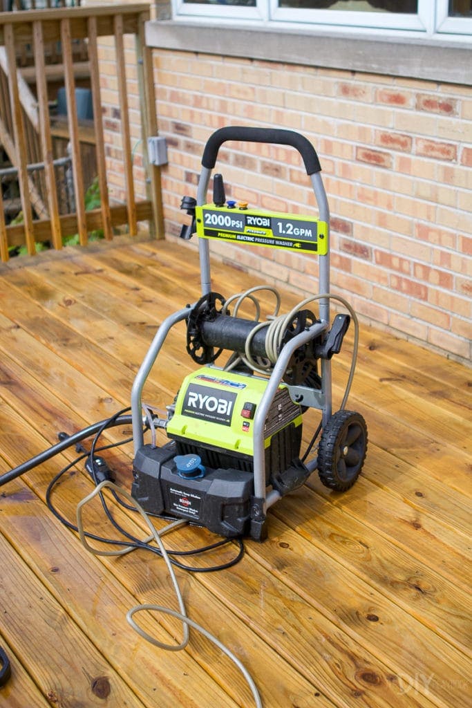 Using a power washer to clean a deck