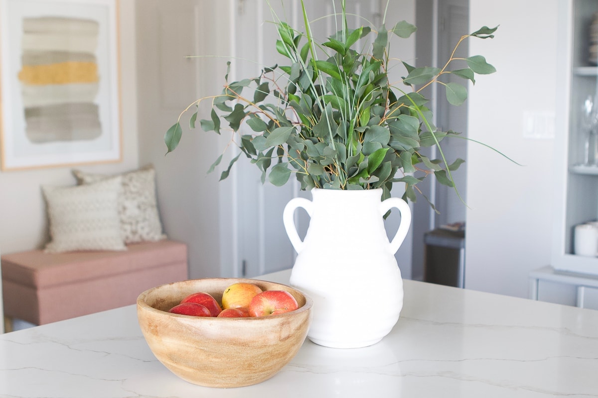 Fruit bowl and fresh eucalyptus on a kitchen counter