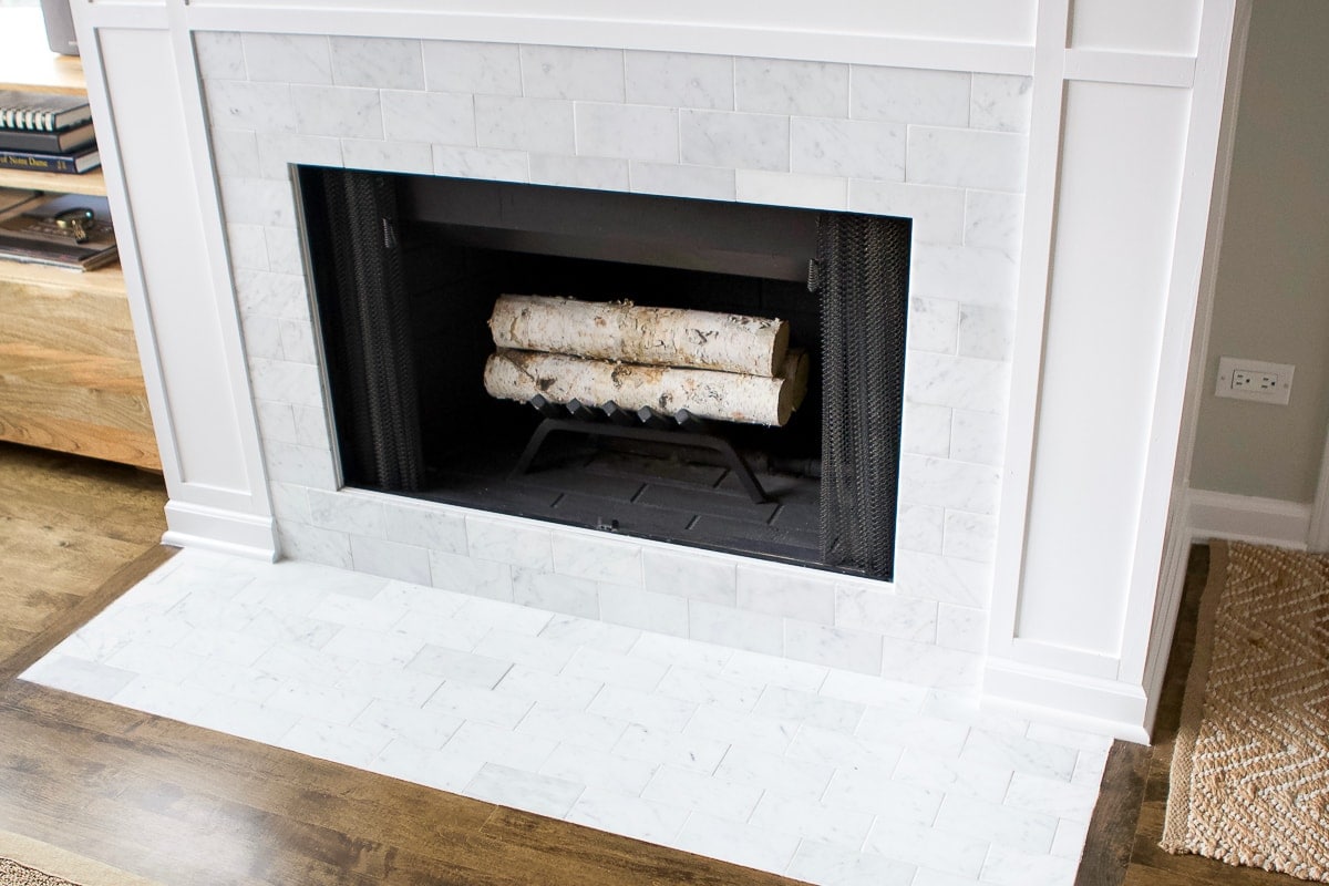 Marble subway tile on a fireplace