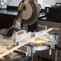 Using a miter saw to cut pieces of lattice