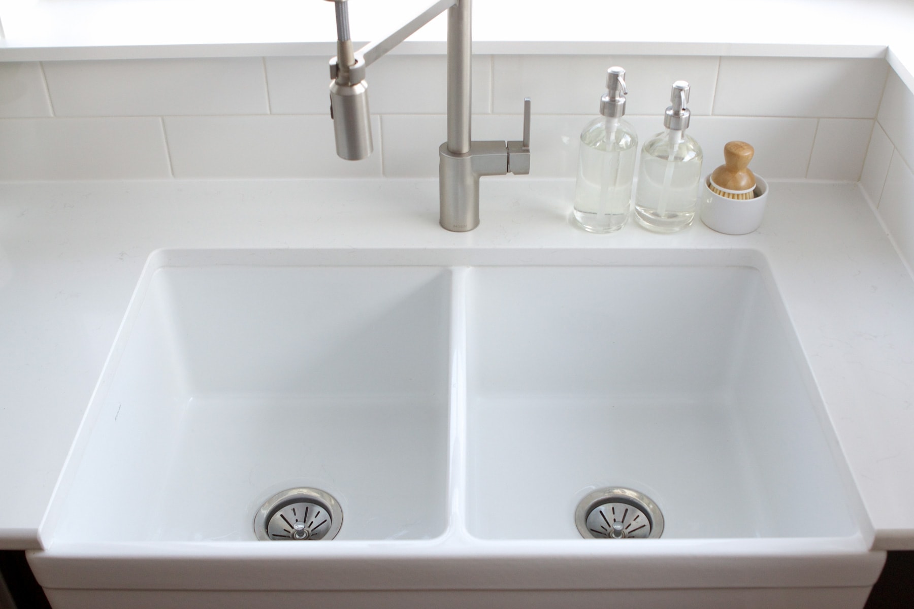 scrubbing a white sink