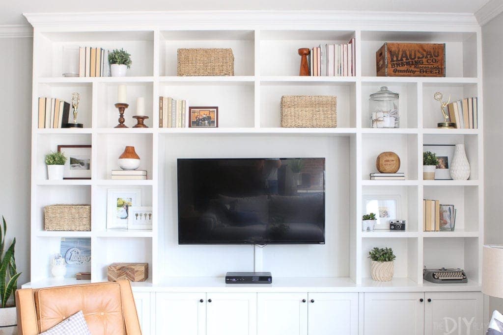White built-ins filled with wicker baskets for storage