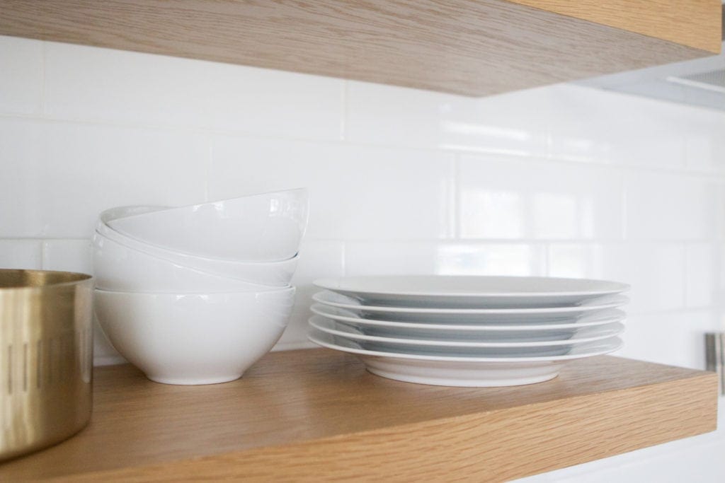 plates and dinnerware on kitchen shelves