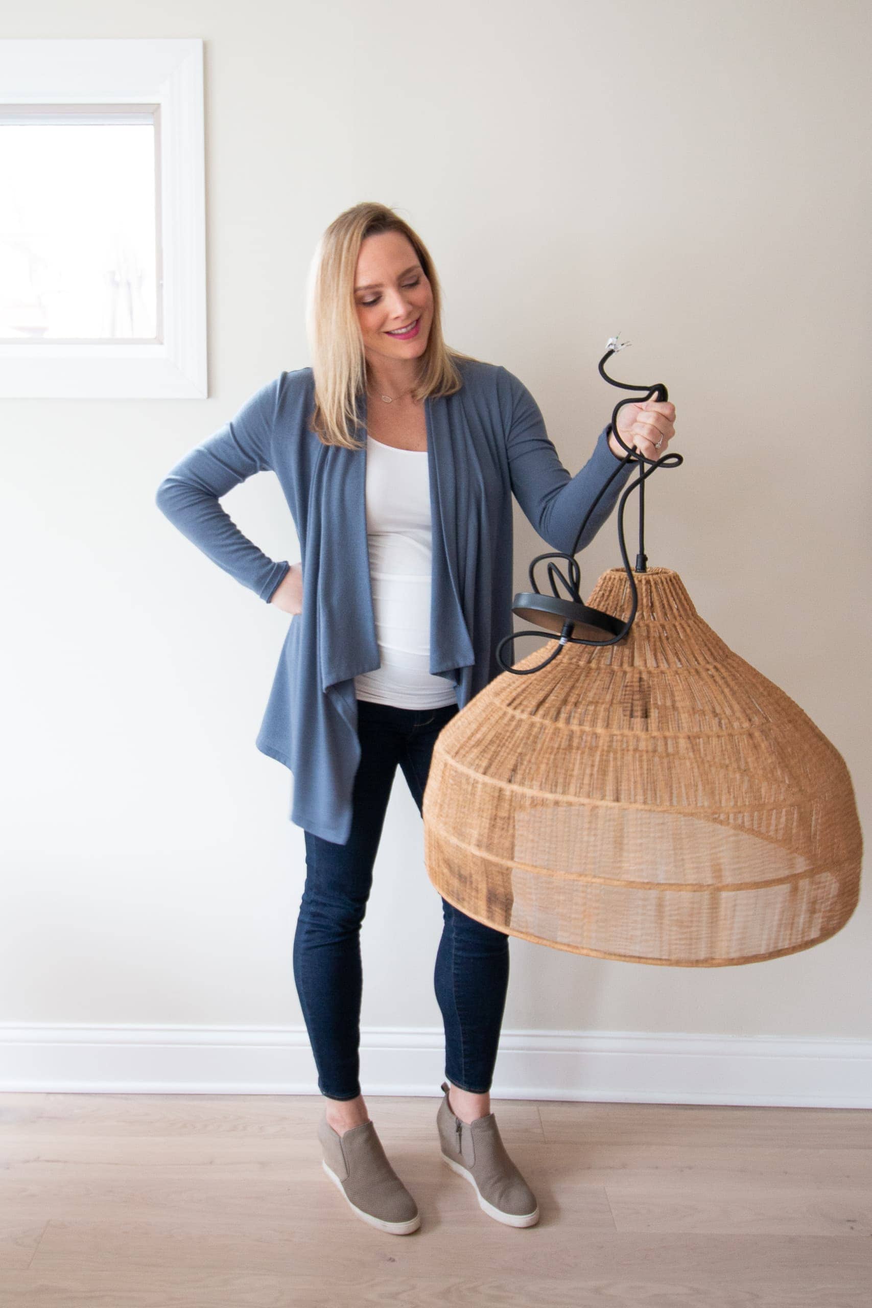 Casey holding light fixture from crate and barrel