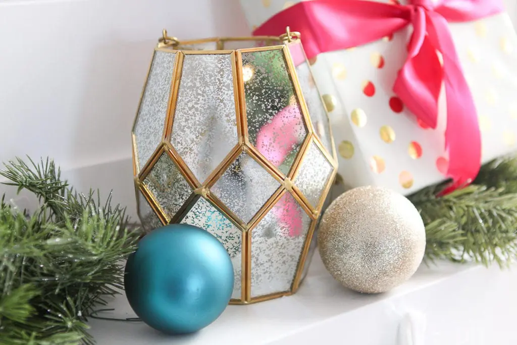 Gold lantern on a fireplace mantle for Christmas