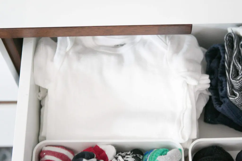white onesies in a baby dresser