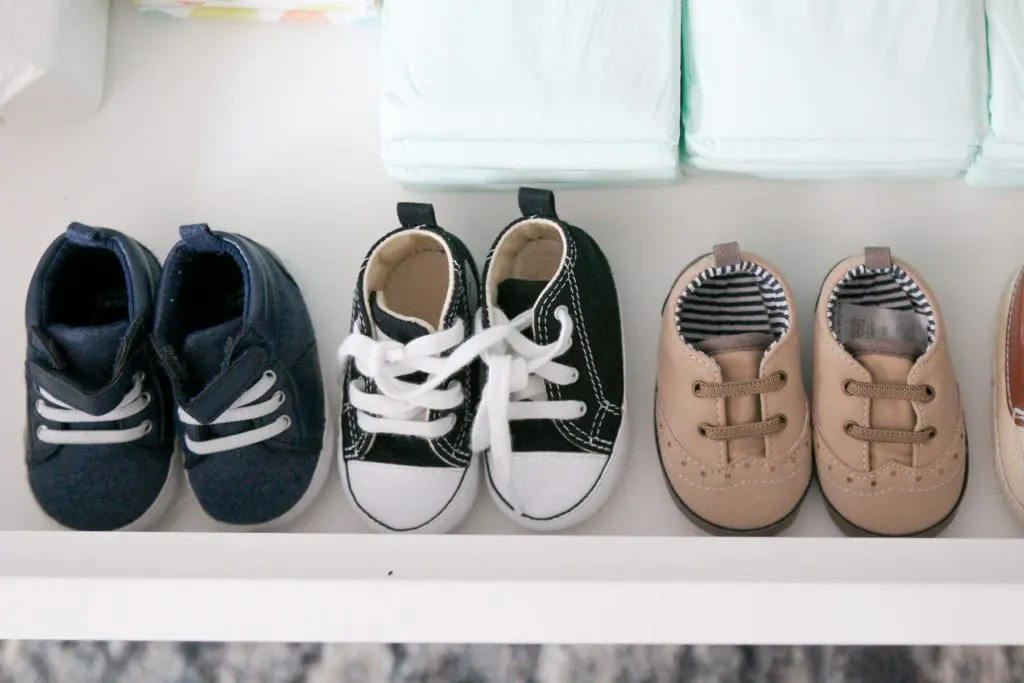 organizing baby shoes in a dresser