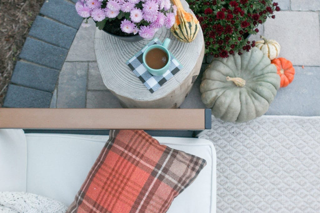 mums and pumpkins and plaid on a fall patio