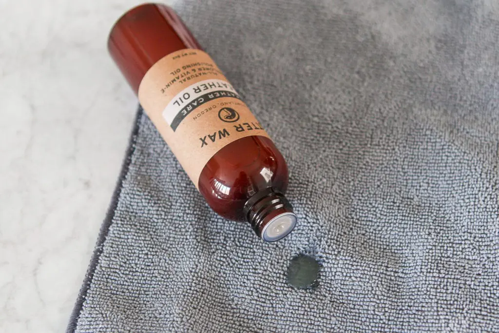 Put a small amount of the leather oil onto a clean cloth