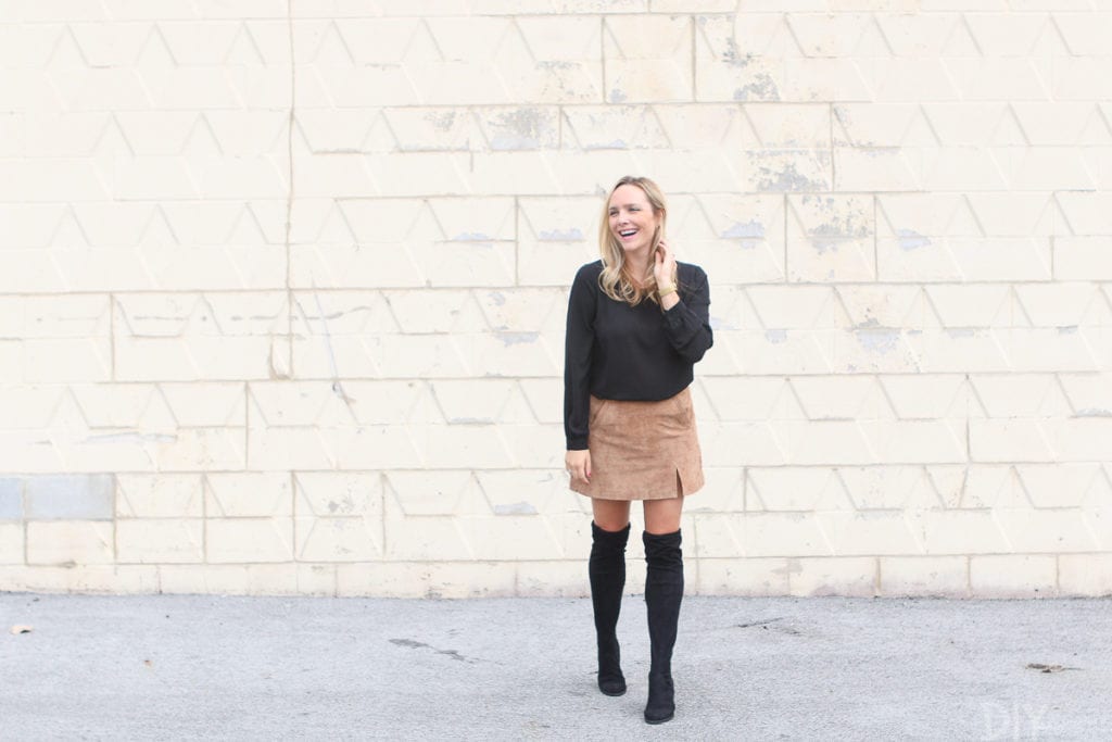 A tan suede skirt with a black blouse
