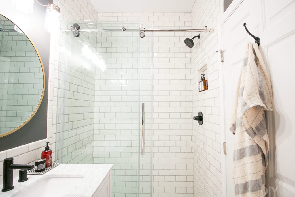 This bathroom feels so much bigger with the subway tile going to the ceiling