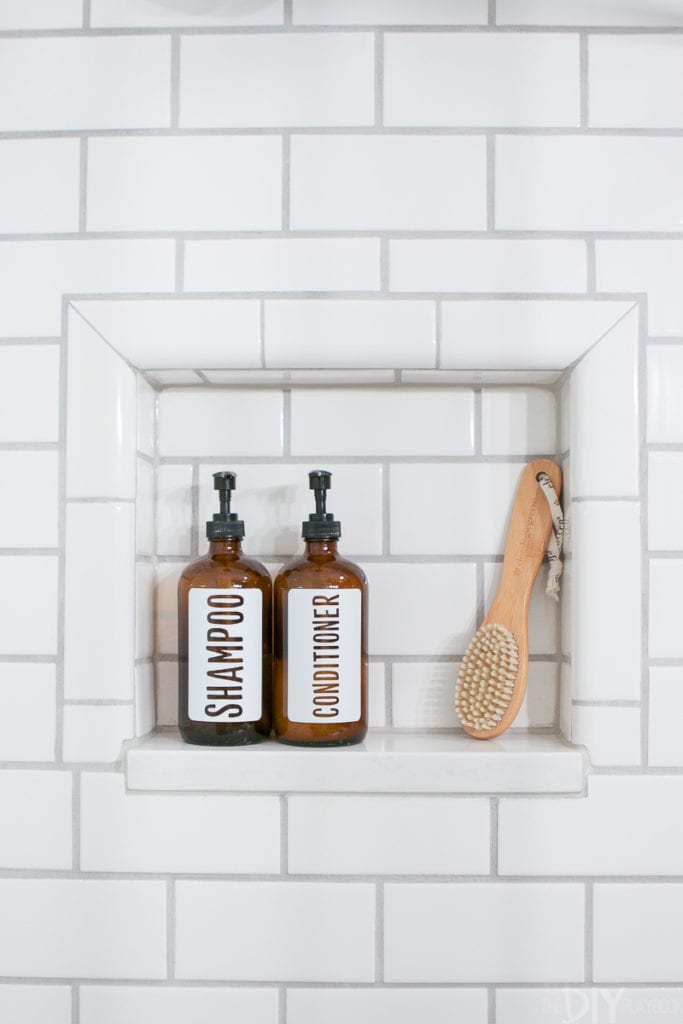 Use pretty glass bottles in a visible shower niche