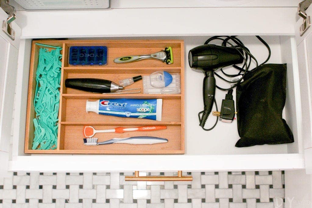 Use a silverware drawer tray to corral small bathroom items. 