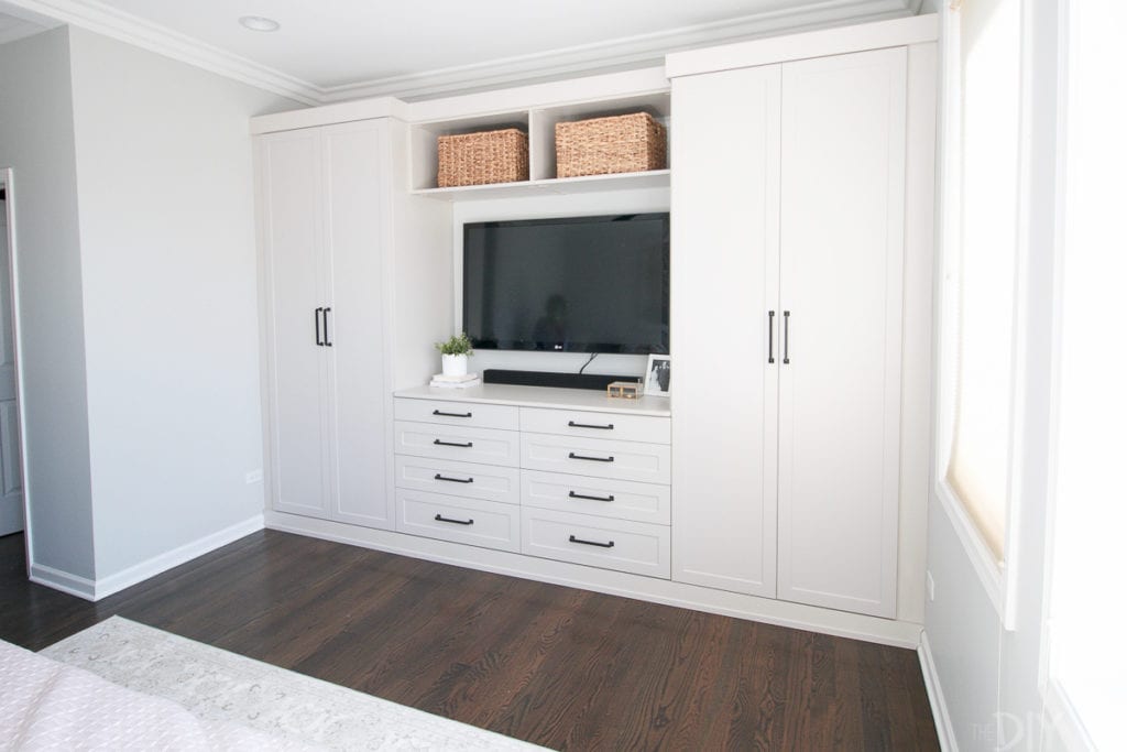 Wall of built-ins in a master bedroom for storage