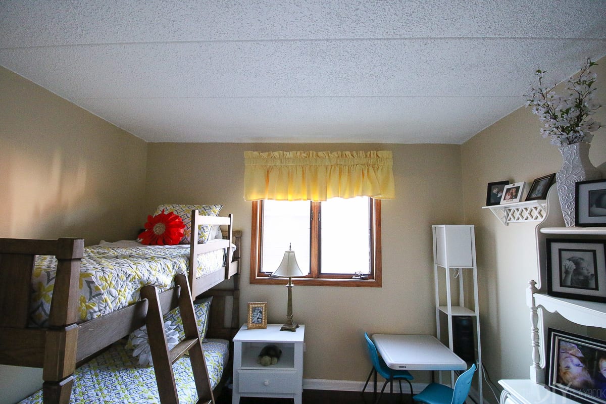 Before pictures of a kids' room makeover with bunk beds and storage