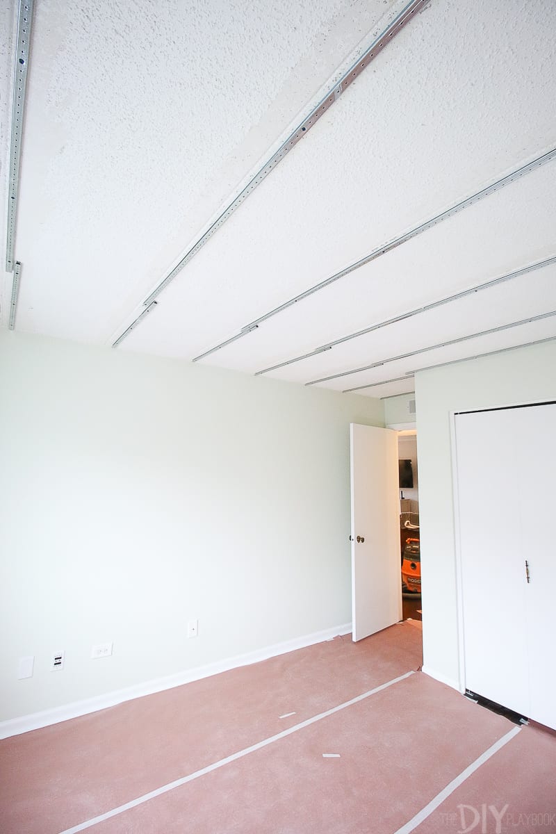 A ceiling covered with metal tracks before adding ceiling planks