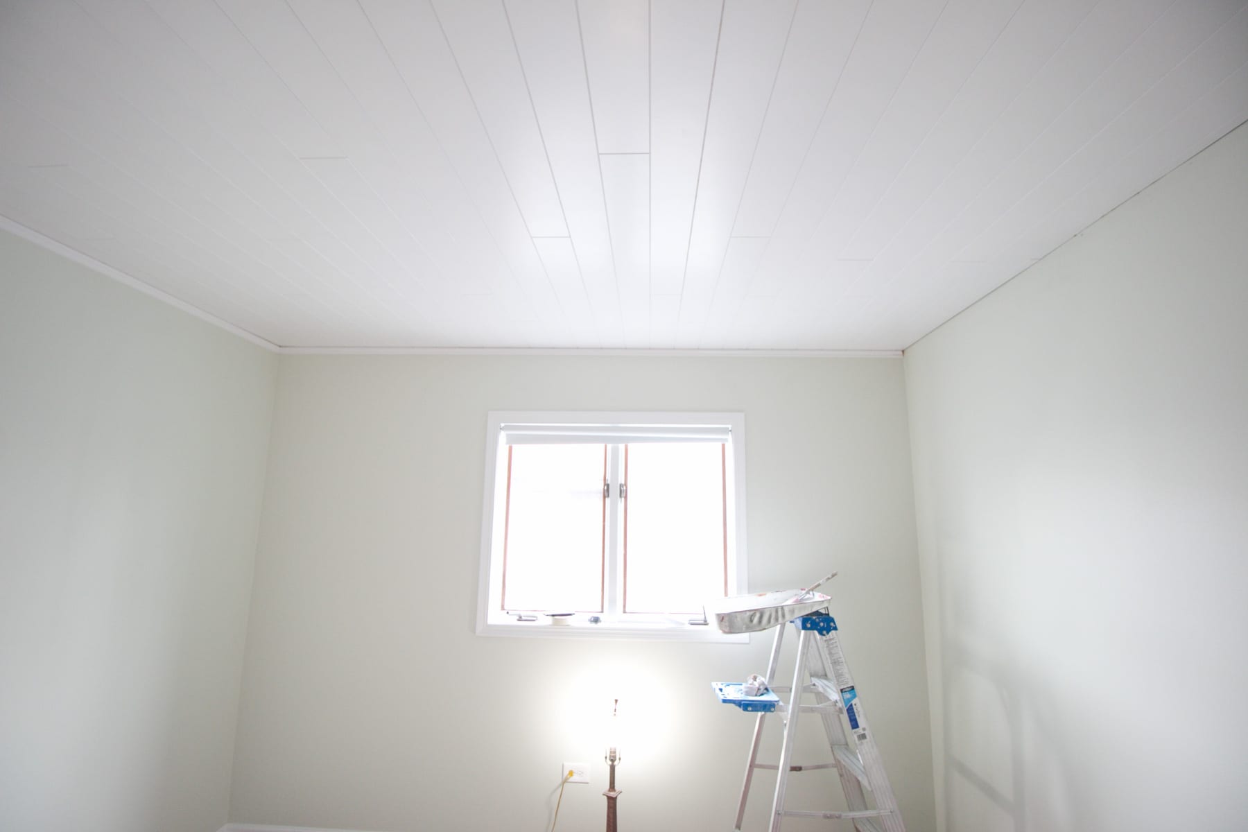 The ceiling after installing planks to cover the popcorn ceiling. 