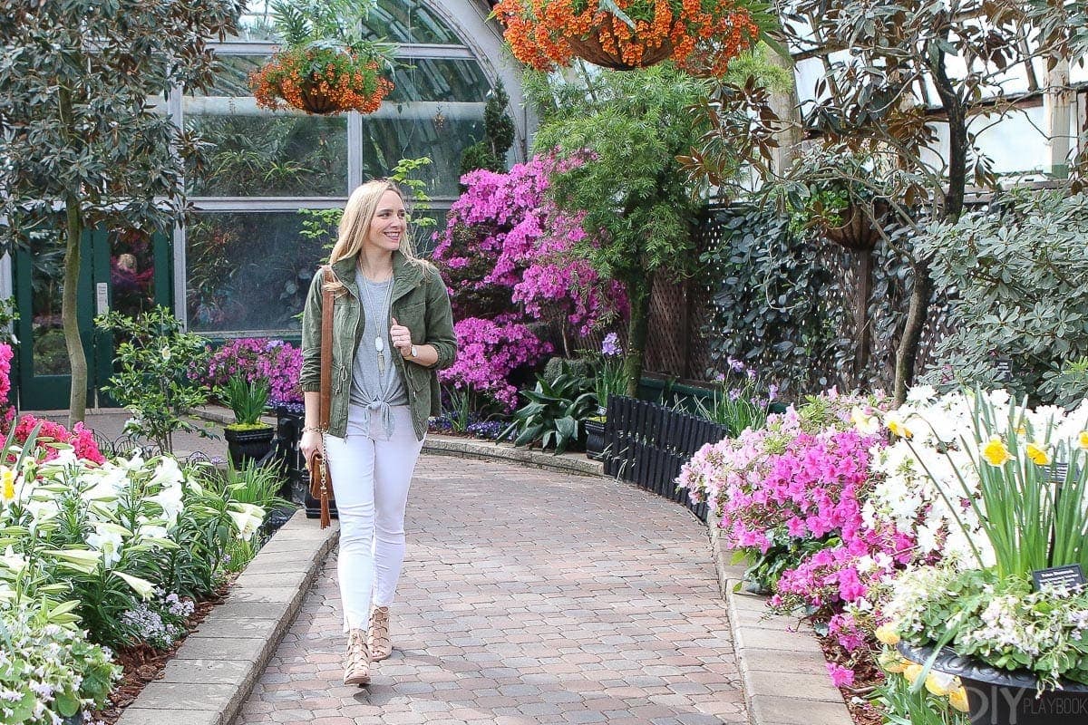 Casey walking through the Lincoln Park conservatory featuring spring clothing