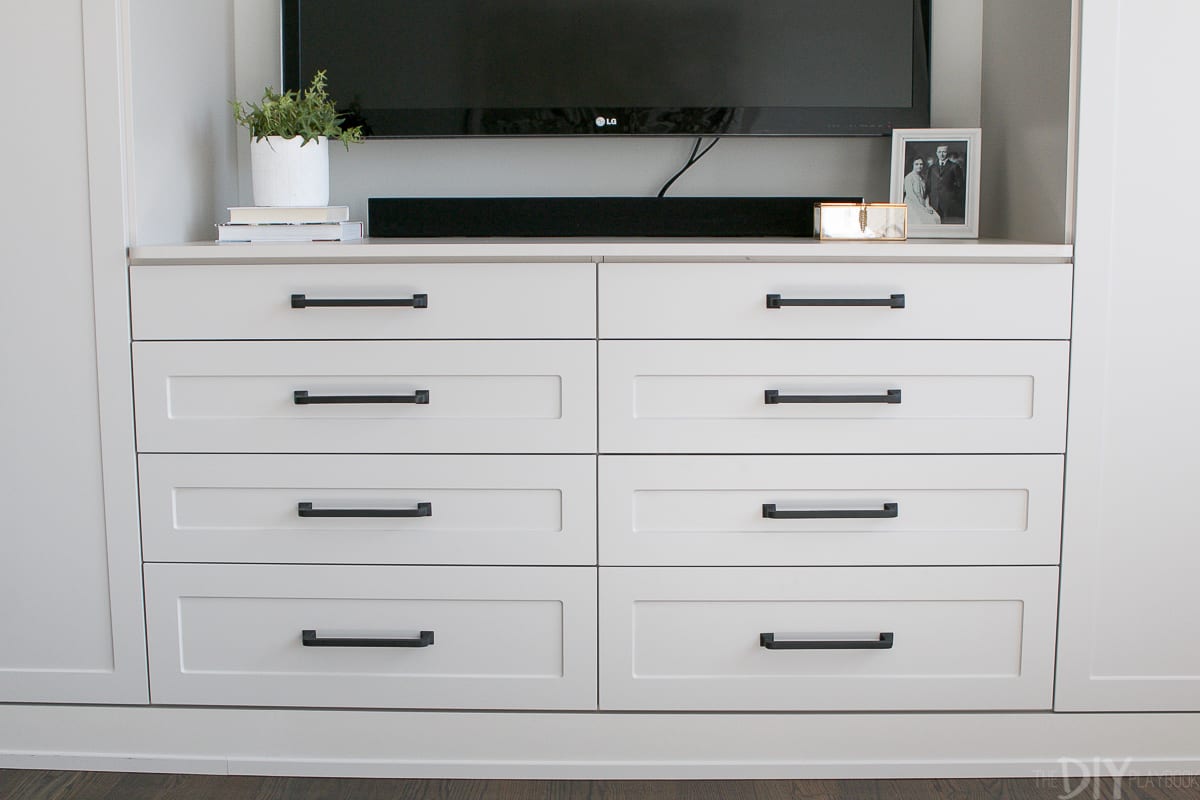 Gray and beige shaker style cabinets on this master bedroom built-in unit. 