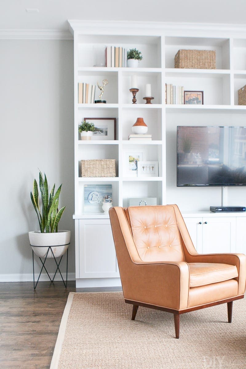 White built-ins with leather chair