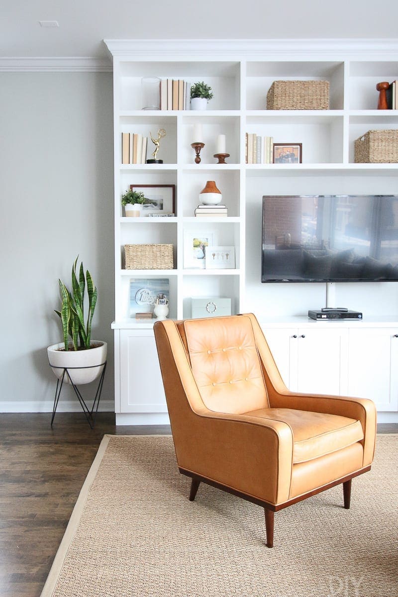 Family Room Built-Ins - check out how great thse look in our living room! I love the contrast of the white shelves with our orange chair. 