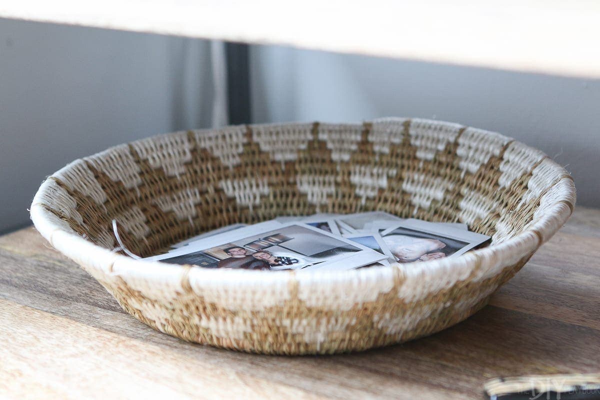 Put polaroid pictures in a basket for personal decor