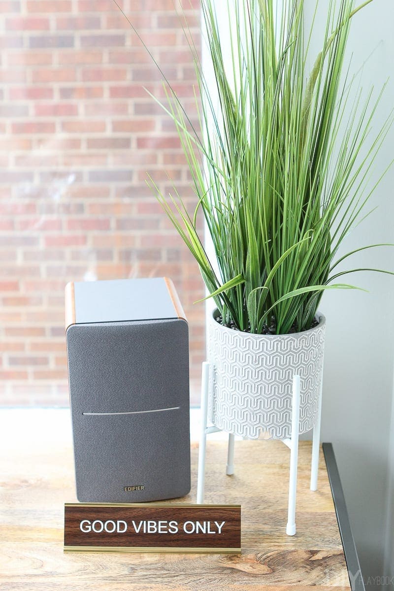 A faux plant from HomeGoods adds height and greenery to this record console