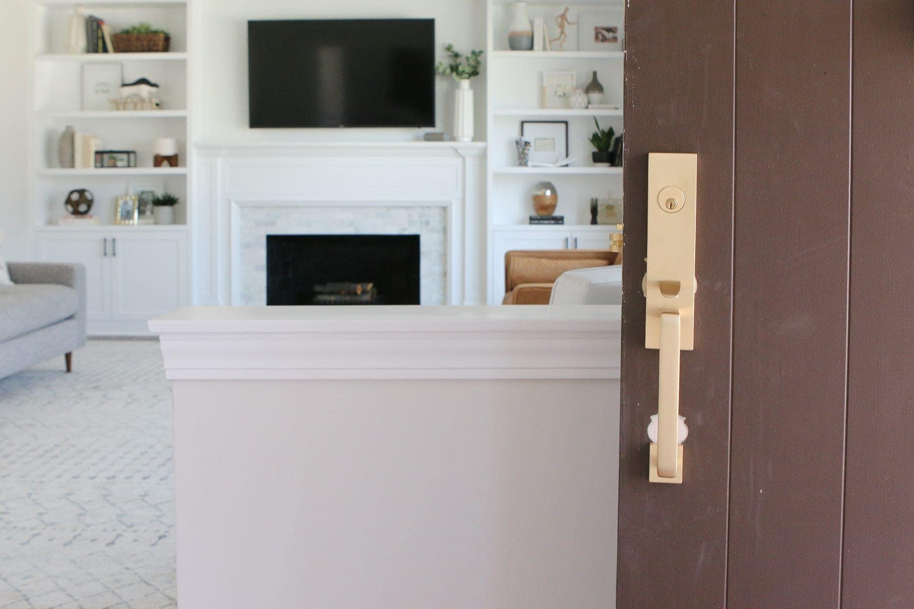 Front door with brown paint and satin brass hardware