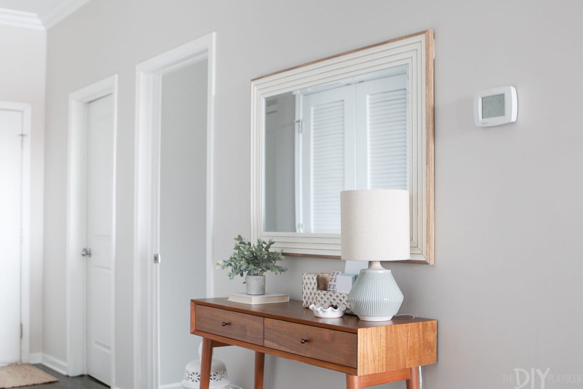 Add a large mirror over a console to create a drop zone in your hallway 