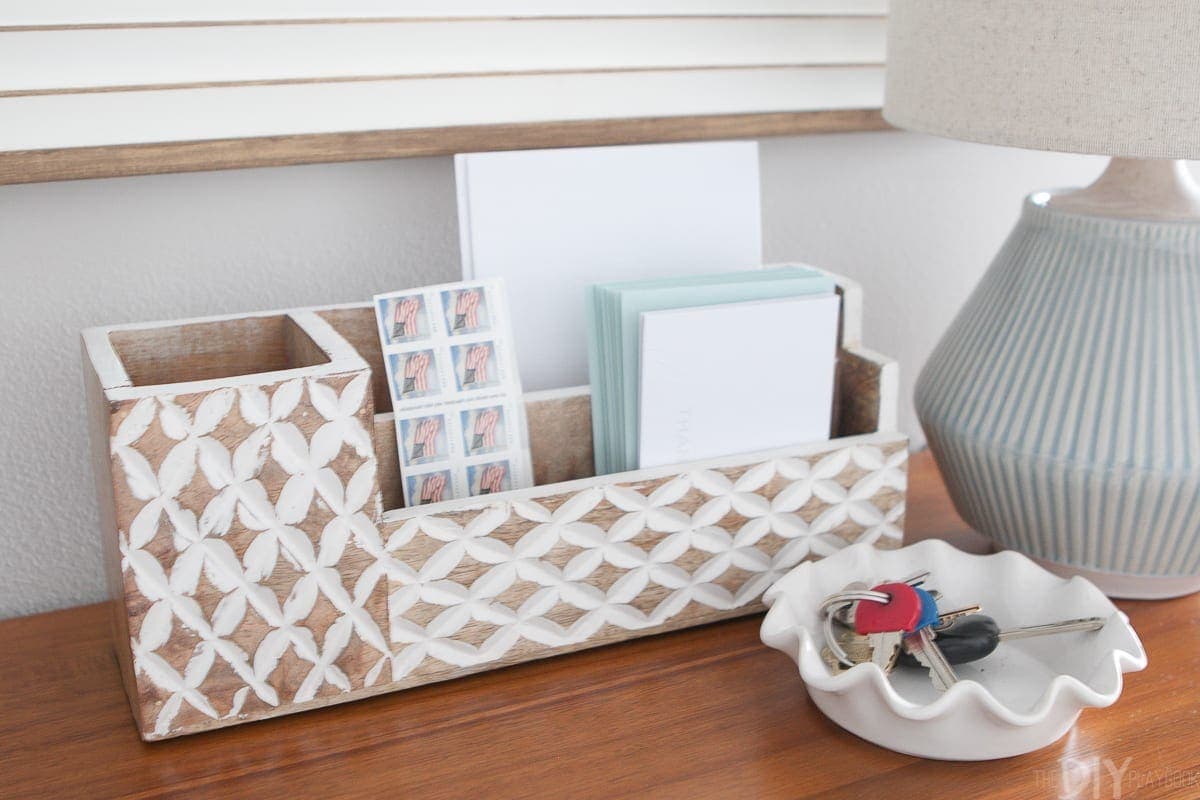 Use a mail sorter and key bowl to corral accessories on your entryway console. 