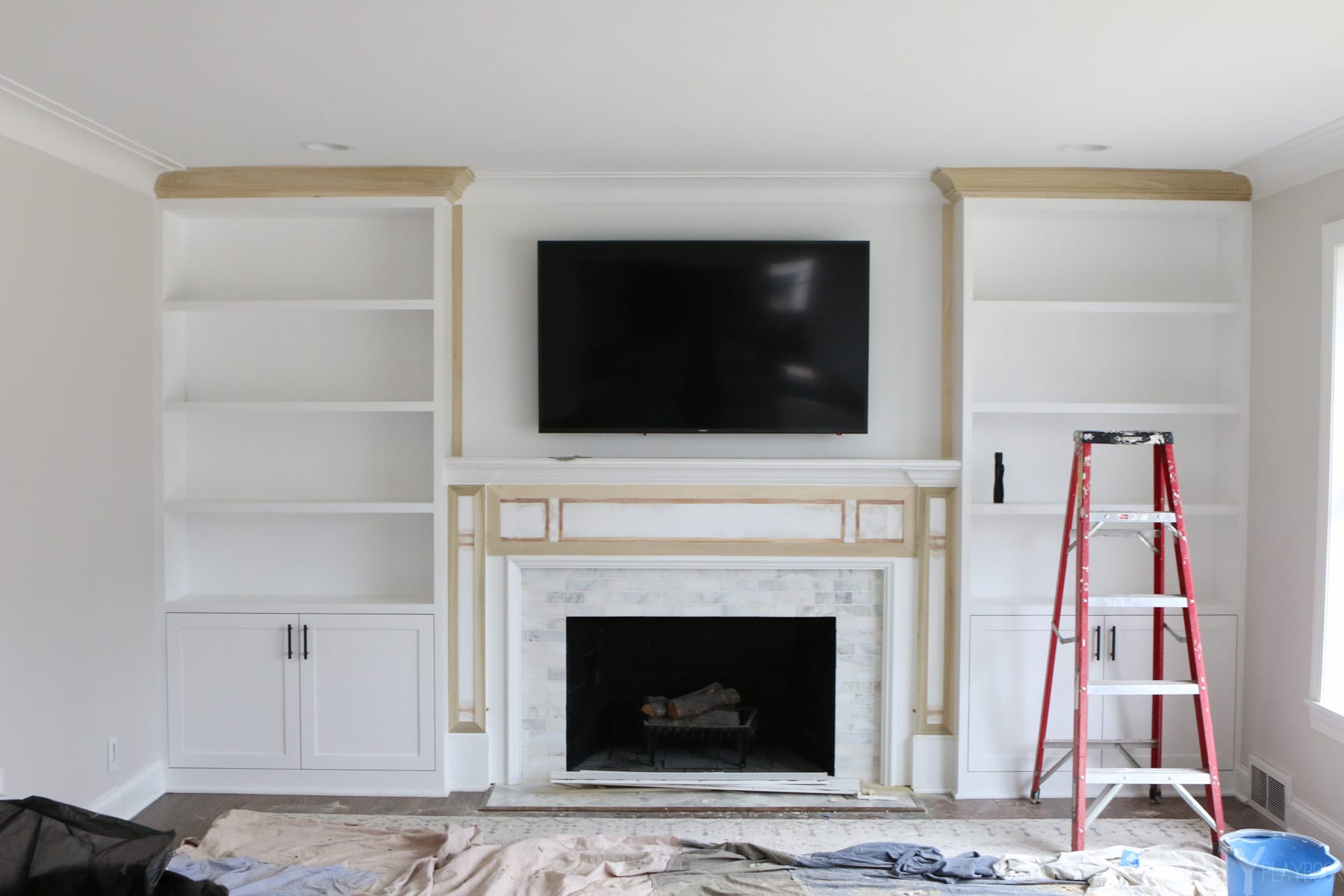 the process of installing Whte Built-Ins Around a Fireplace