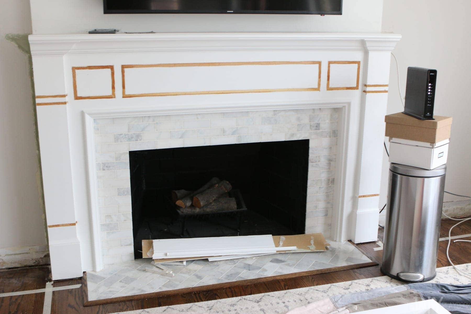 changing the wood detail before installing Whte Built-Ins Around a Fireplace