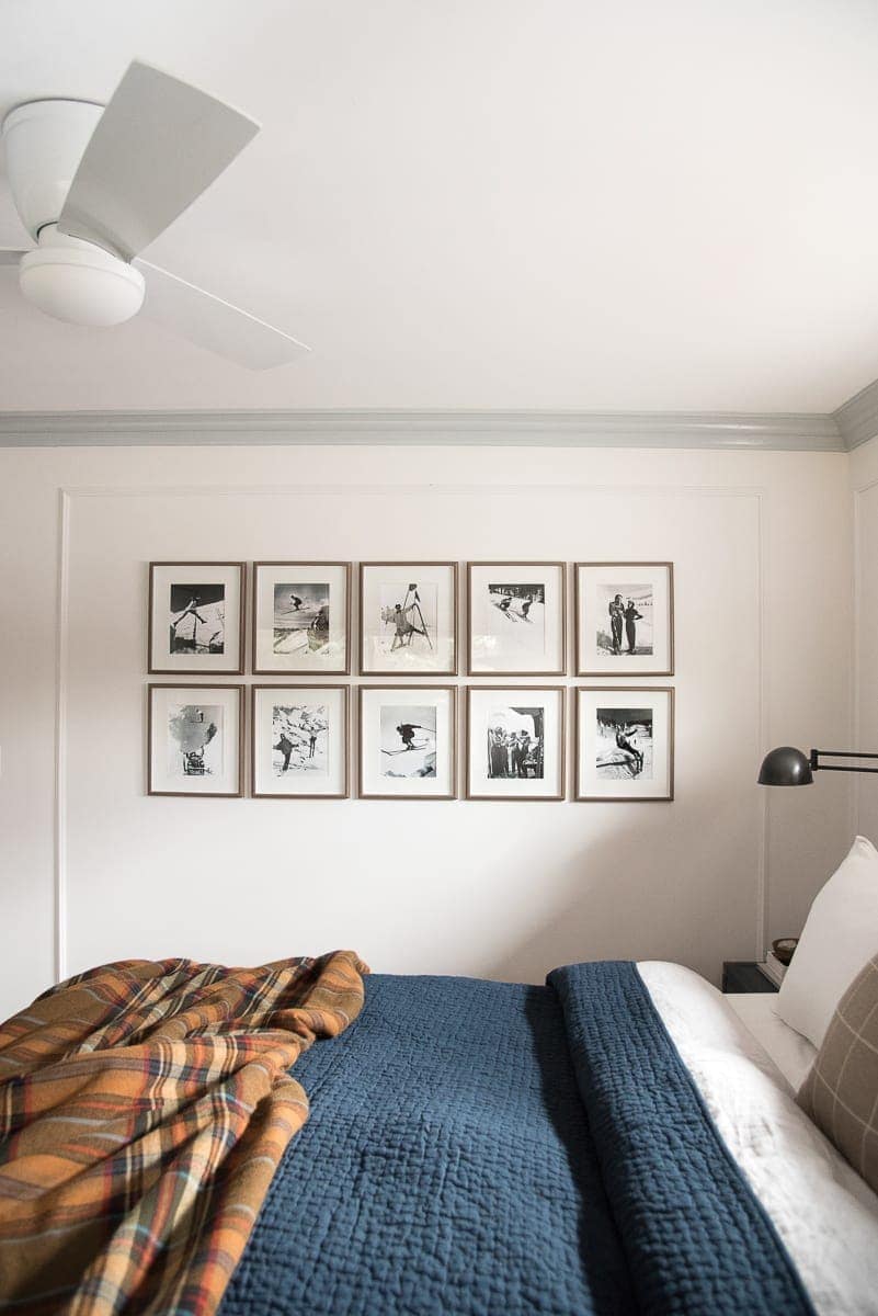 Symmetrical gallery wall hanging in a master bedroom.